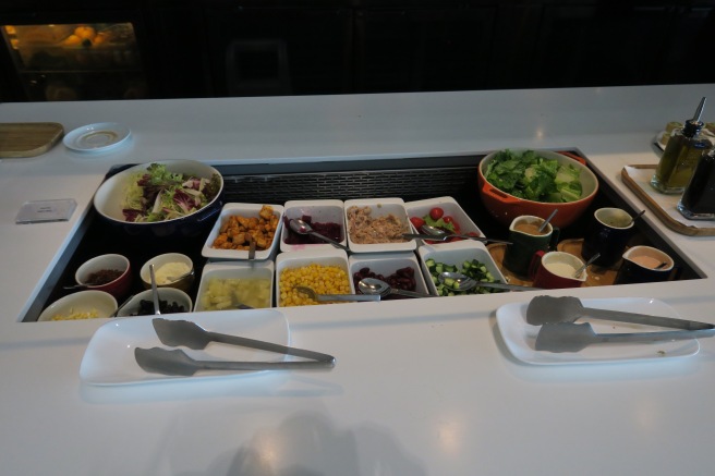 a buffet table with bowls of food