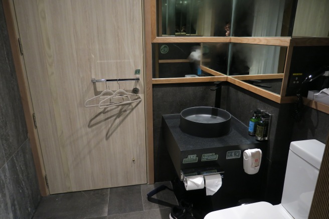 a bathroom with a mirror and a sink