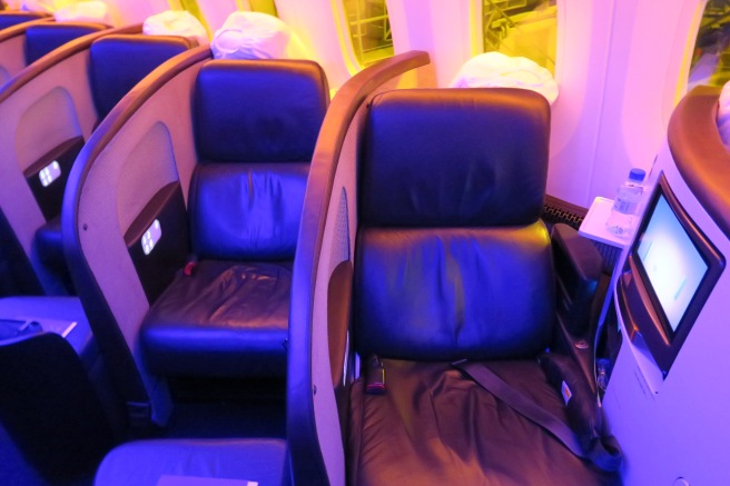 a row of black chairs in a plane