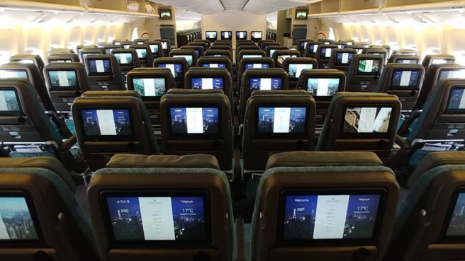 rows of seats with screens on them