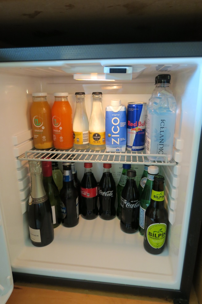 a refrigerator with bottles of drinks