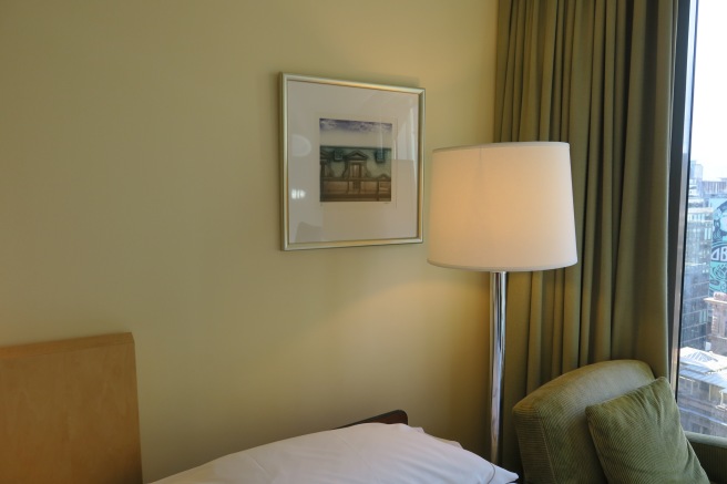 a lamp next to a bed