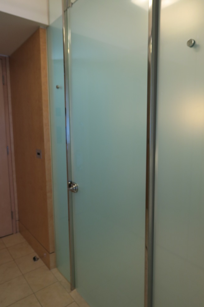 a glass shower door in a bathroom