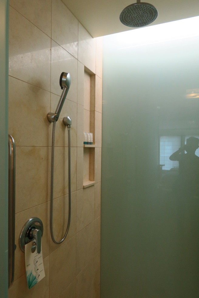 a shower with a shower head and a shower head