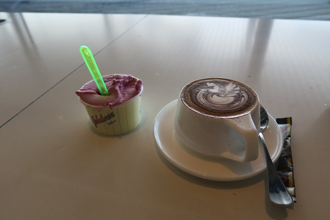 a cup of coffee and a spoon on a table