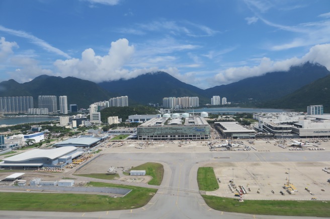 a large city with buildings and mountains in the background