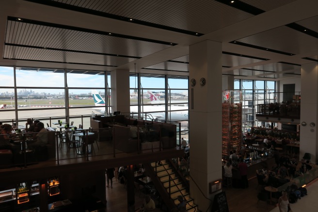 a large room with a large window and a plane in the background