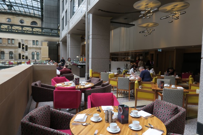 a group of people sitting at tables in a restaurant