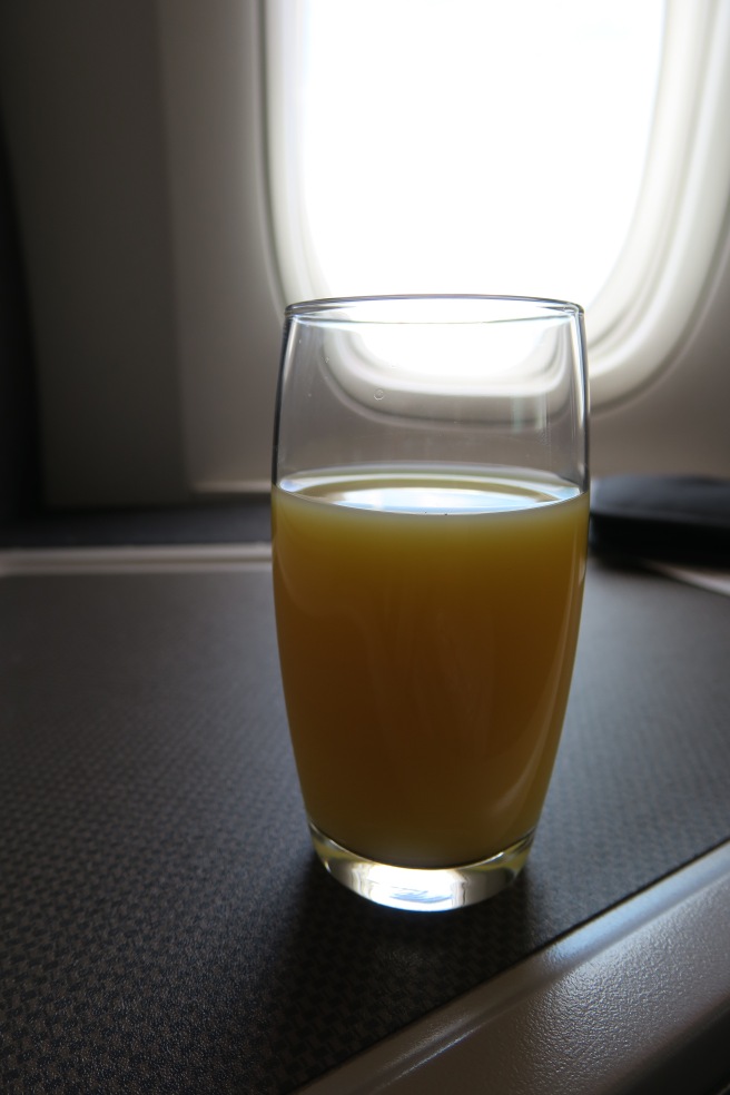 a glass of orange juice on a table