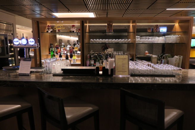 a bar with many glasses and bottles