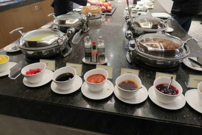 a buffet table with bowls of food