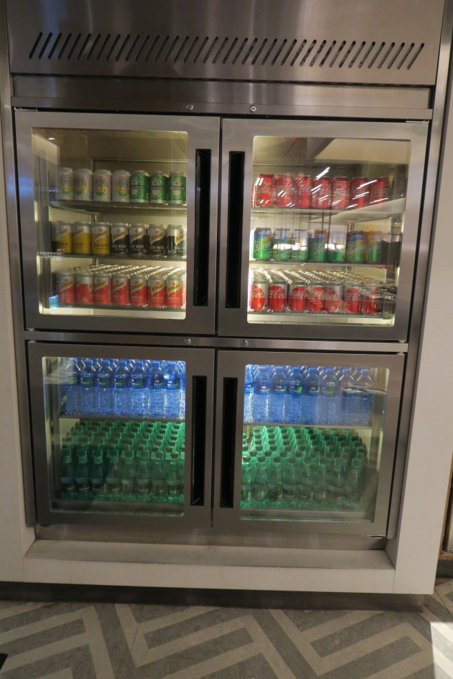 a refrigerator with drinks and cans