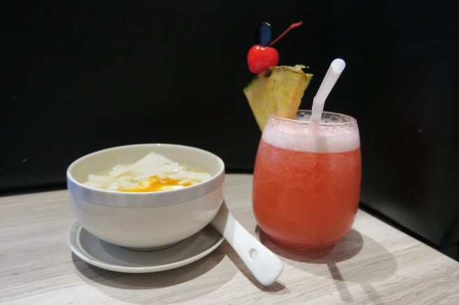 a bowl of food and a drink on a table