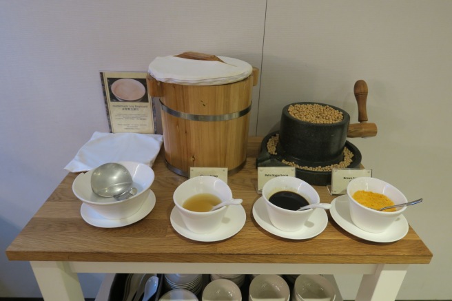 a table with bowls of soup and beans