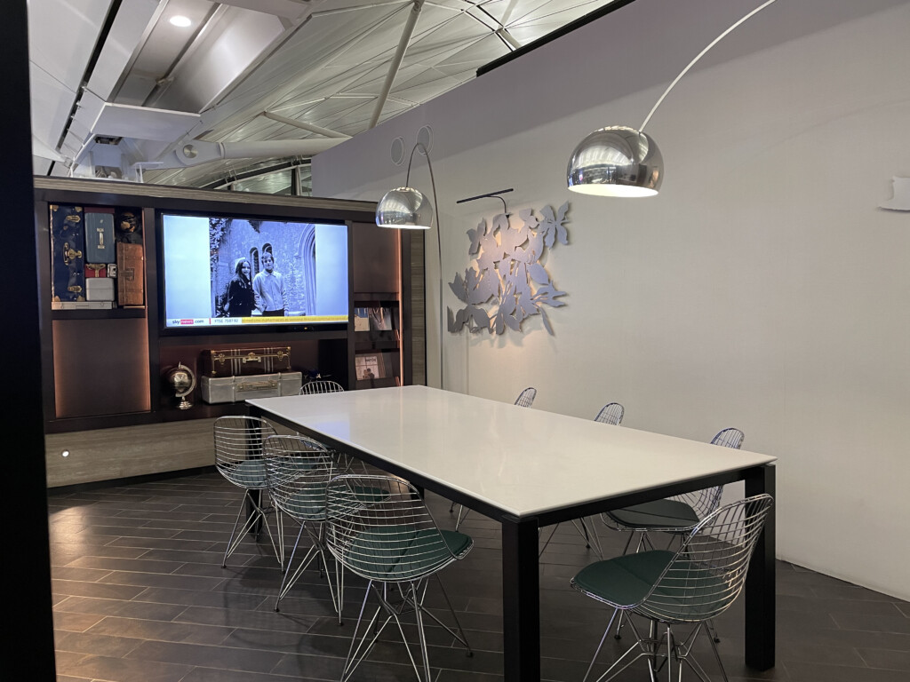 a table with chairs in a room with a television