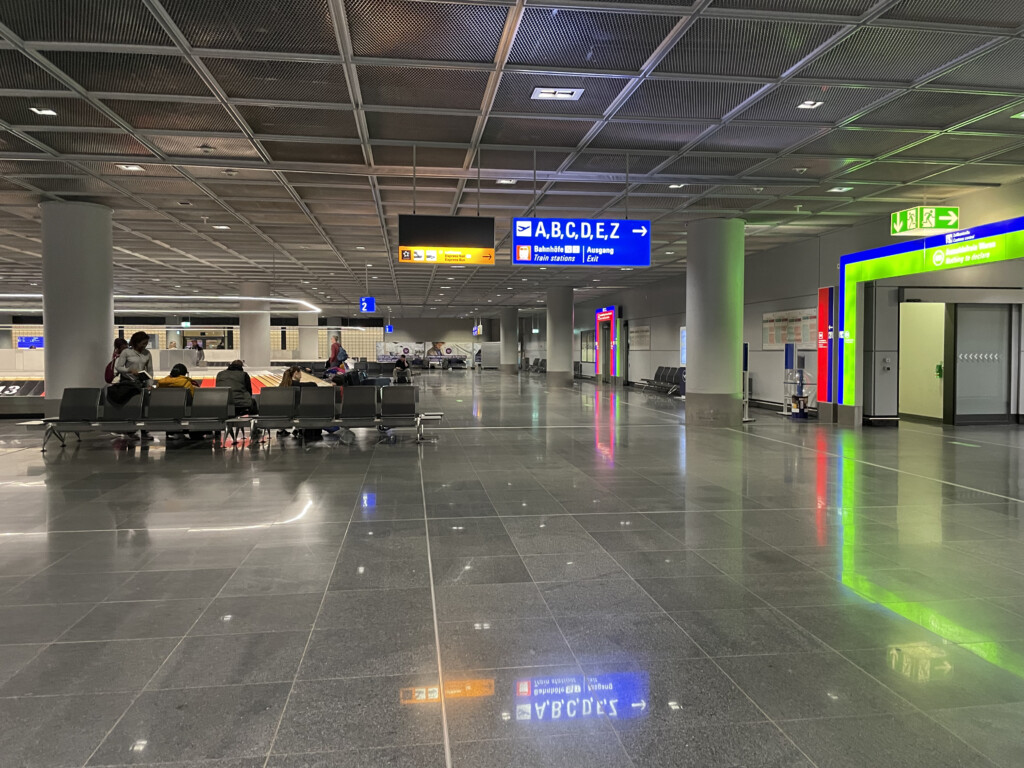 a group of people sitting in a large airport terminal