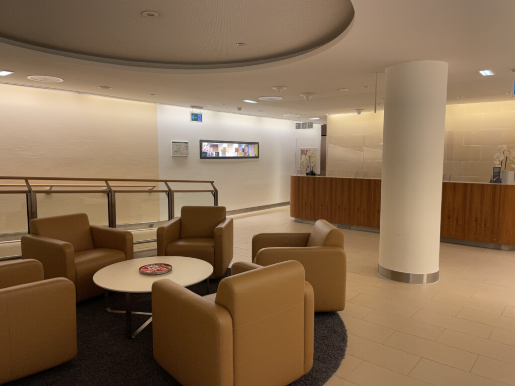 a room with a round table and chairs