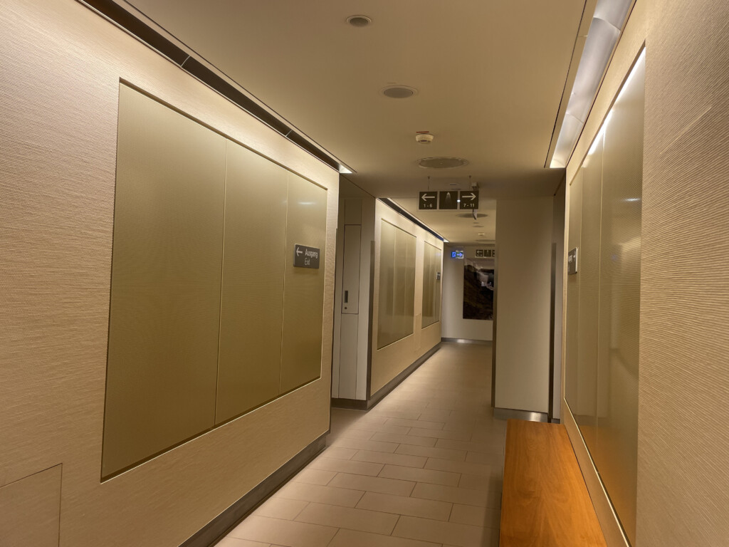 a hallway with a bench and doors