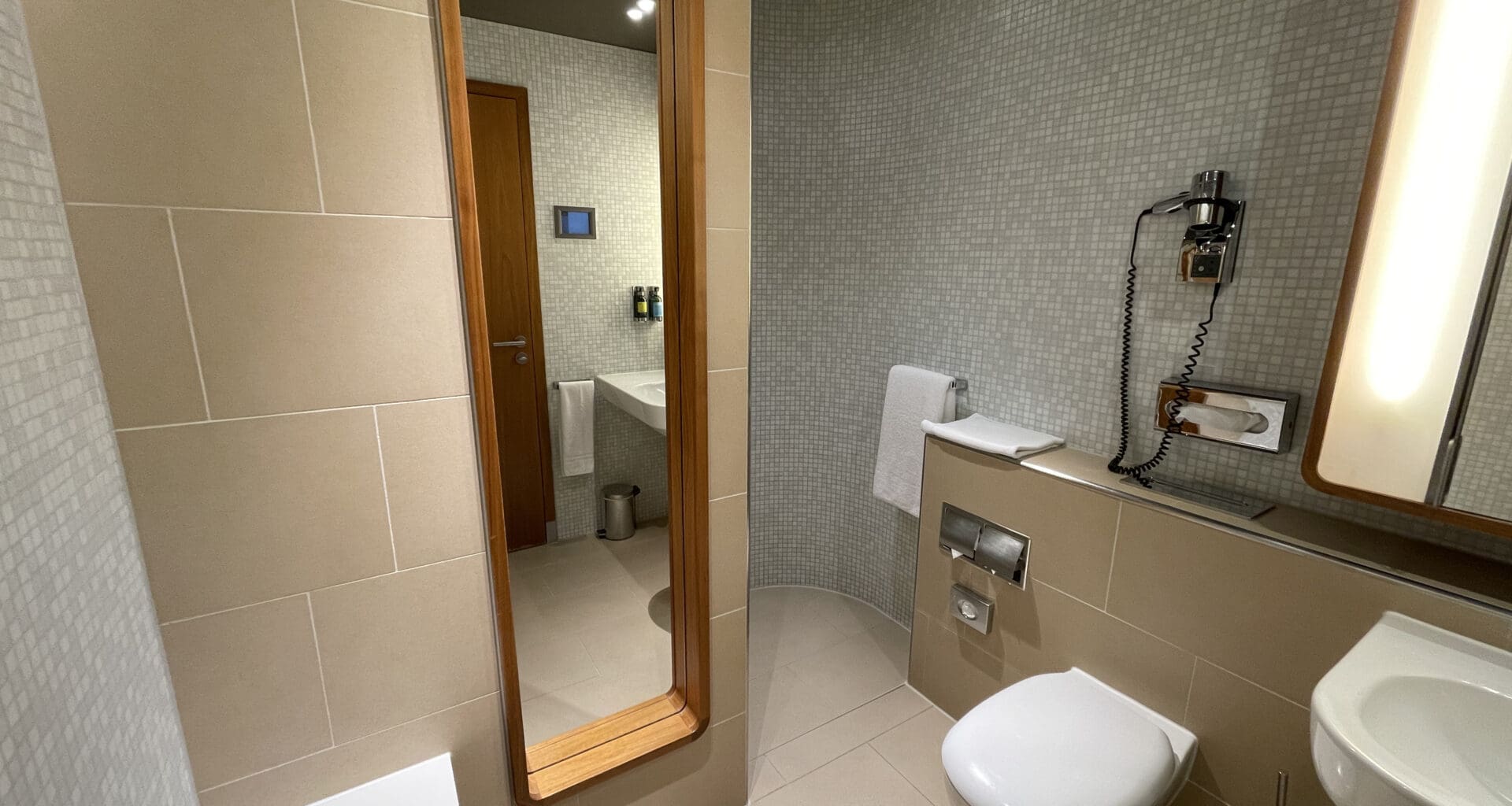 a bathroom with a mirror and toilet