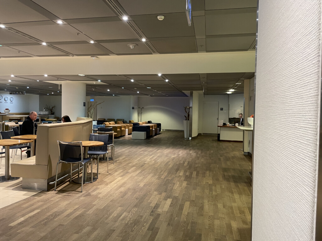 a room with a reception desk and chairs