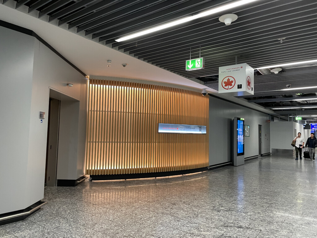 a hallway with signs and a wall