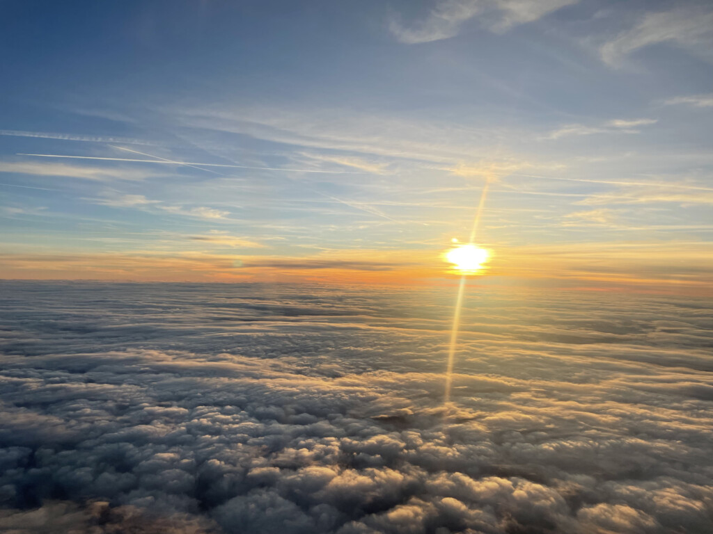 a sun setting over clouds