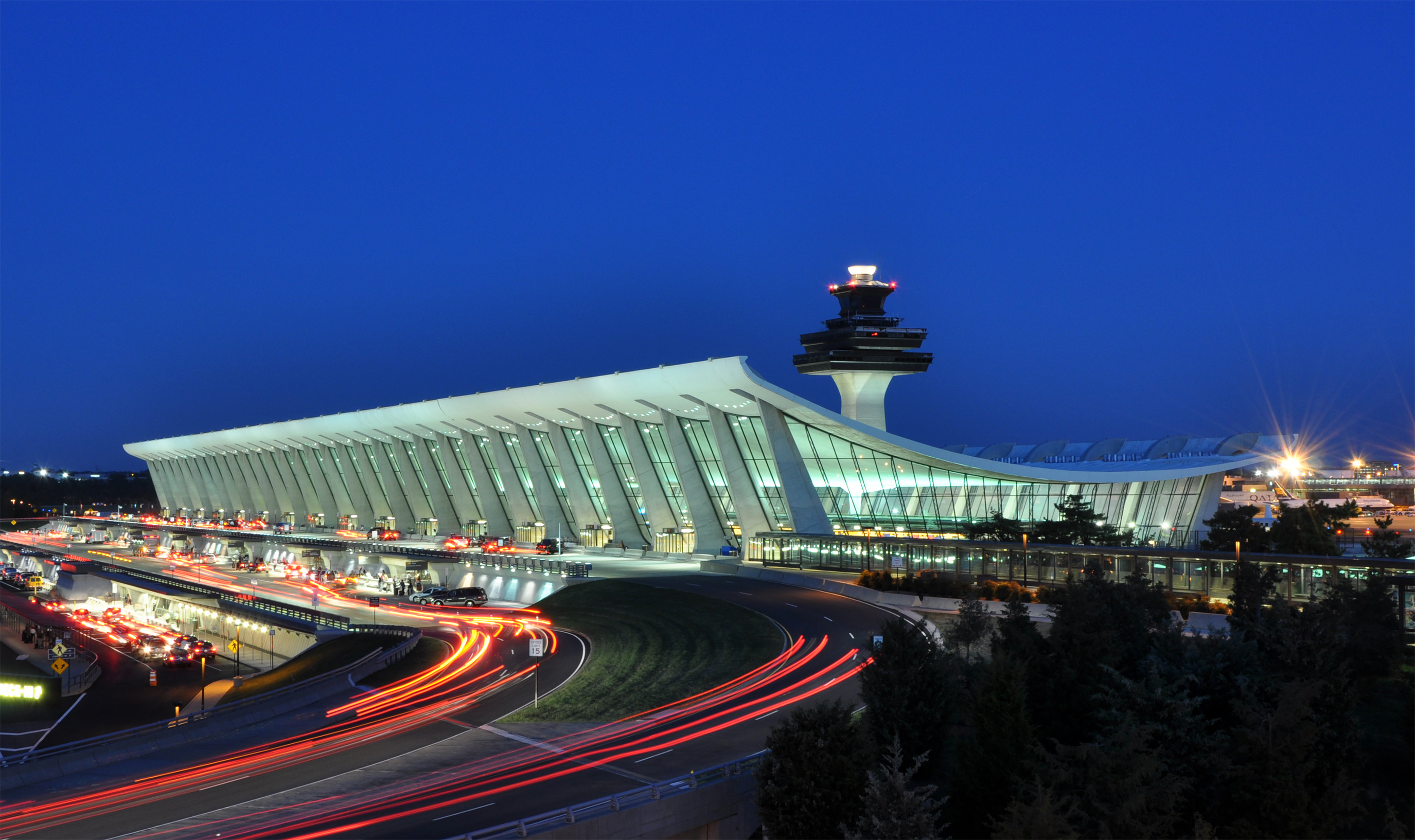 a large airport with a tower and a traffic tower