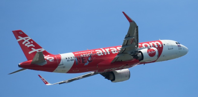 a red and white airplane in the sky