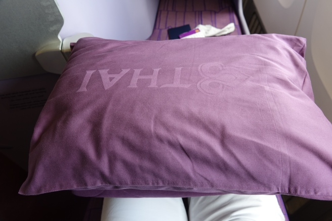 a purple pillow on a chair