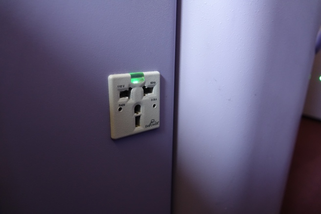 a white outlet with green light on it