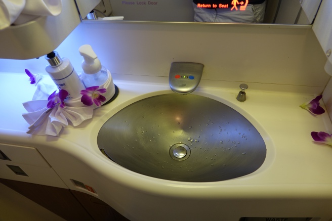 a sink with soap and soap bottles on it