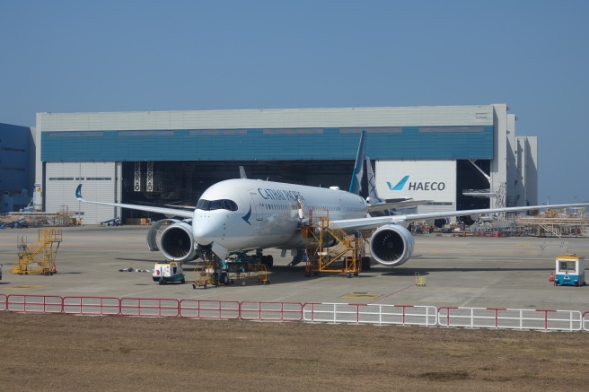 a white airplane in a hangar