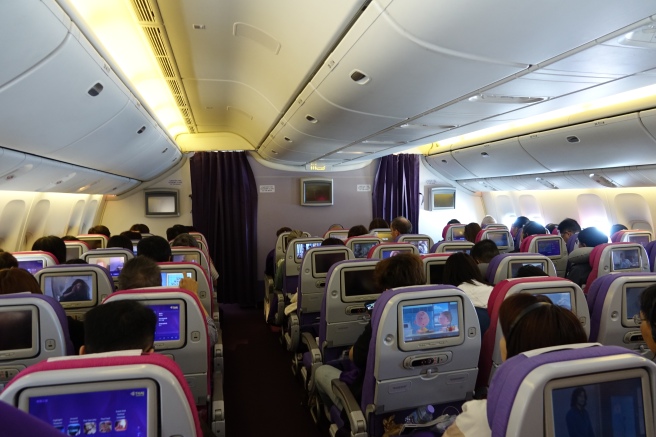 a group of people sitting in an airplane