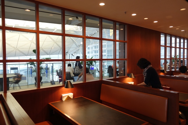 a woman sitting at a table in a restaurant