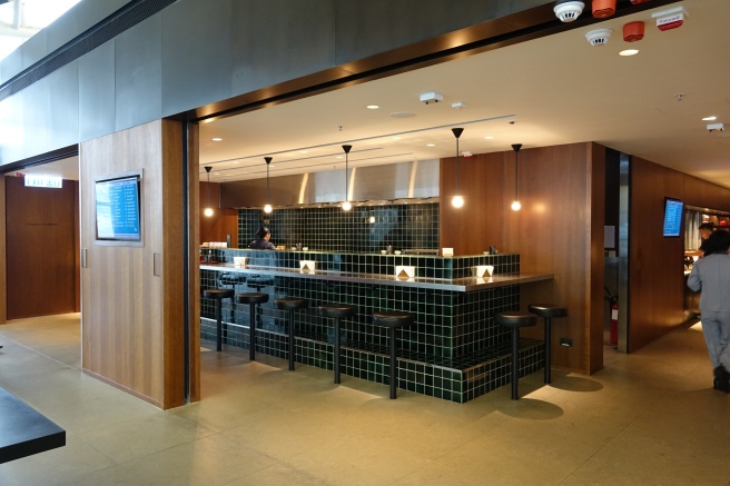 a bar with stools and lights