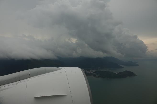 a view of a body of water and mountains from an airplane