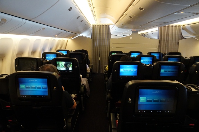 a row of seats with monitors on the back