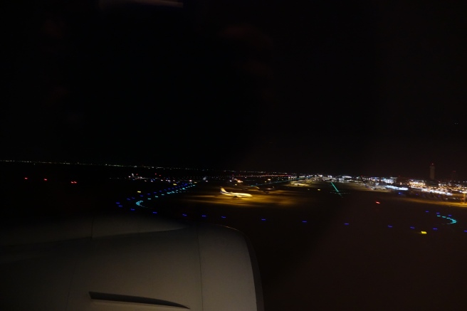 an airplane flying over a city at night