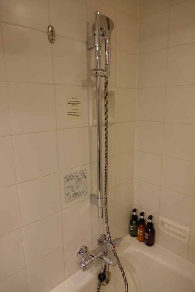 a shower head in a bathroom