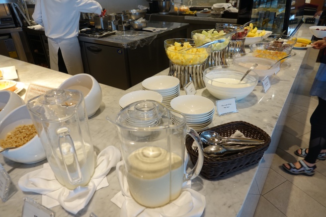 a buffet table with bowls of food