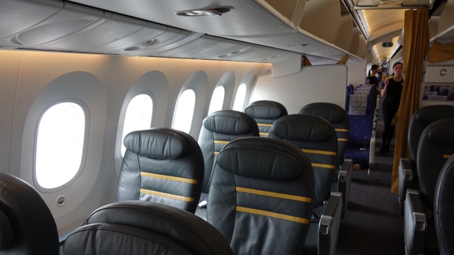 a row of black seats in an airplane