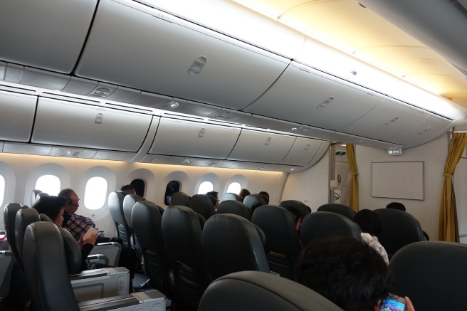 a group of people sitting in an airplane