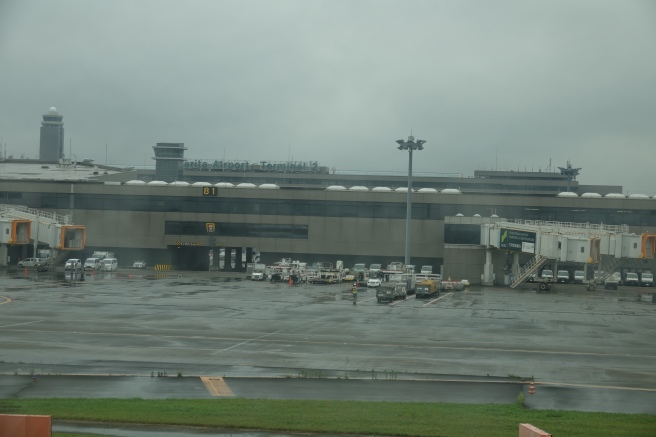 a large building with a lot of vehicles parked outside