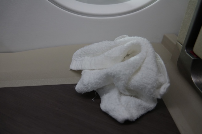 a white towel on a shelf