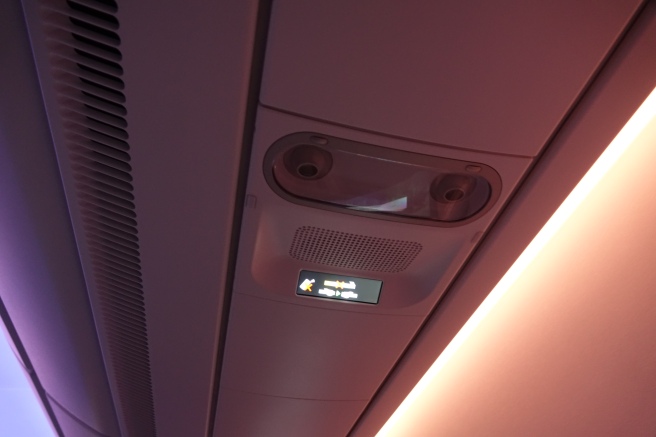 a sign on the ceiling of a plane