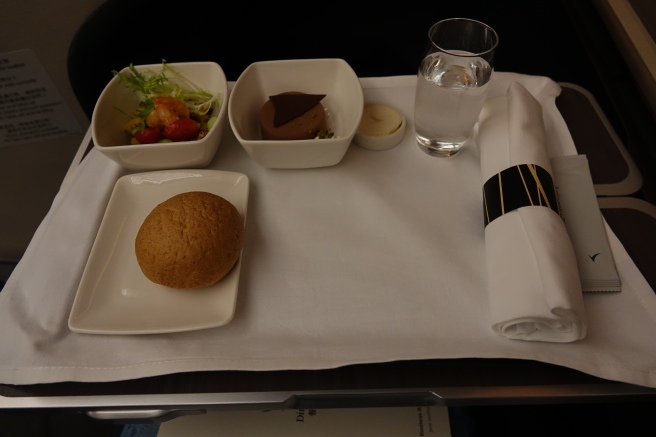 a plate of food and a glass of water on a table