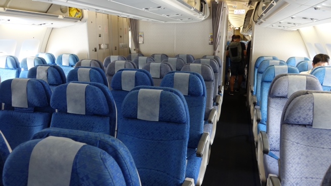 a row of blue seats on an airplane