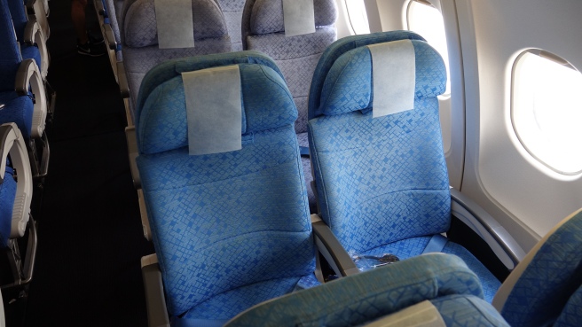 a row of blue seats on an airplane