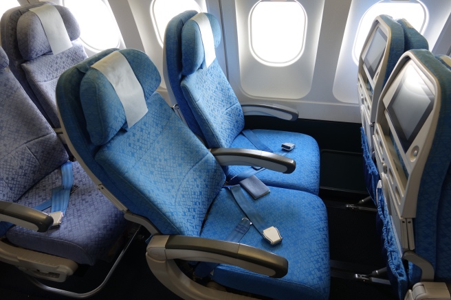 a row of blue seats in an airplane