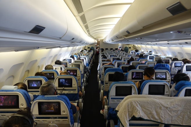 a group of people sitting in an airplane